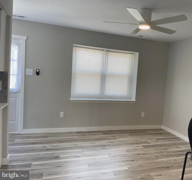 unfurnished living room featuring light wood-style flooring, baseboards, visible vents, and ceiling fan