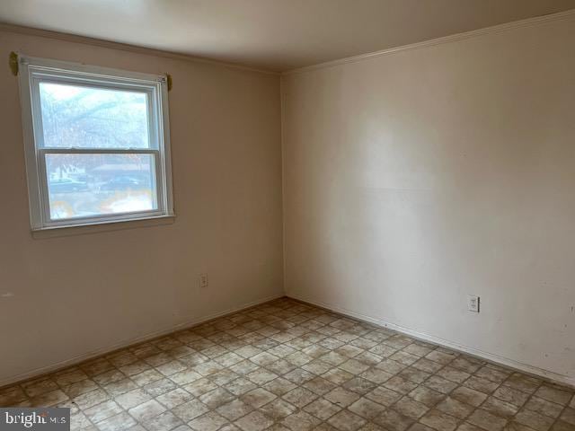 unfurnished room with light floors and ornamental molding