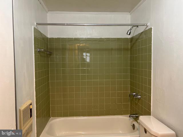 bathroom with  shower combination, toilet, and ornamental molding