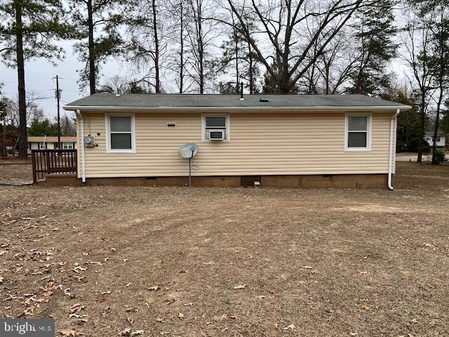 back of property featuring crawl space