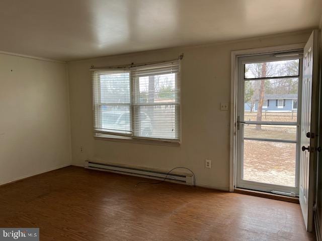 interior space with baseboard heating and wood finished floors