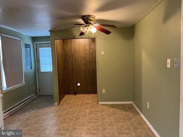 unfurnished bedroom with a baseboard heating unit, baseboards, and ceiling fan