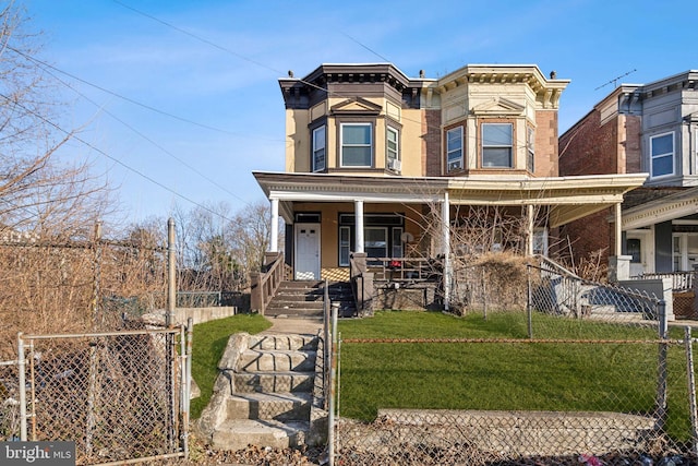 italianate home with covered porch, a front lawn, and fence