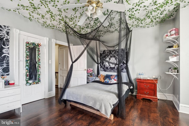 bedroom with baseboards and wood finished floors