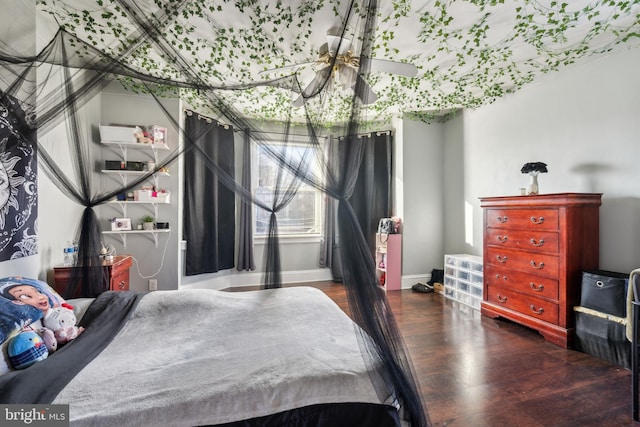 bedroom featuring baseboards and wood finished floors