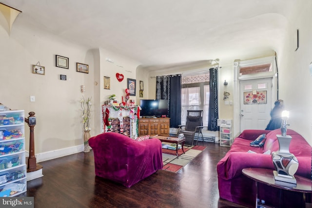 living room featuring baseboards and wood finished floors