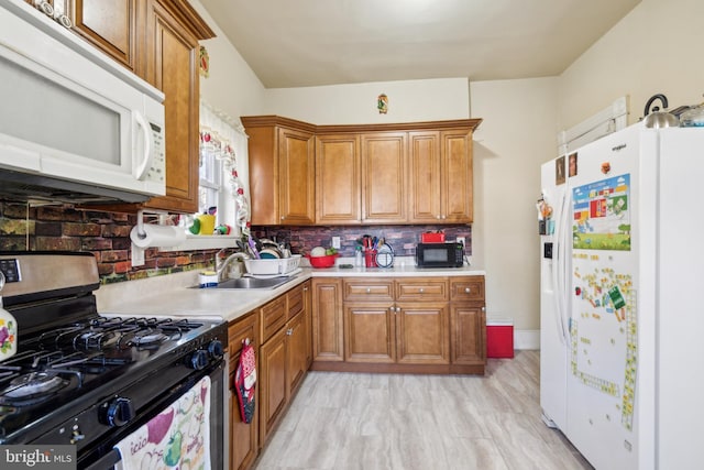 kitchen with white appliances, a sink, light countertops, brown cabinets, and backsplash