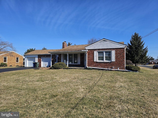 ranch-style home featuring a garage, brick siding, a chimney, and a front lawn