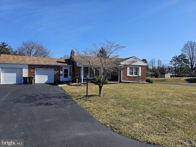 single story home with driveway, a front yard, an attached garage, brick siding, and a chimney