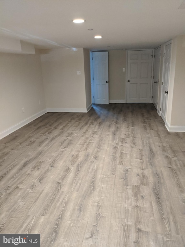 unfurnished room featuring recessed lighting, baseboards, and wood finished floors