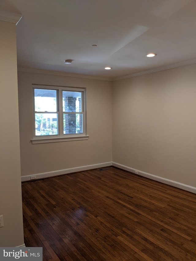 unfurnished room featuring recessed lighting, dark wood-style flooring, crown molding, and baseboards