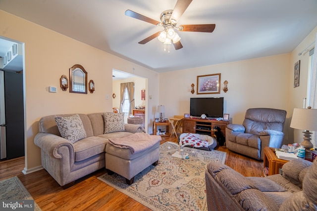 living area featuring ceiling fan and wood finished floors