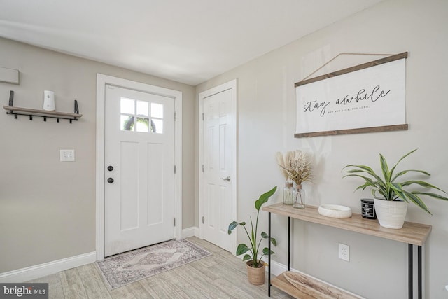 entrance foyer featuring baseboards and wood finished floors