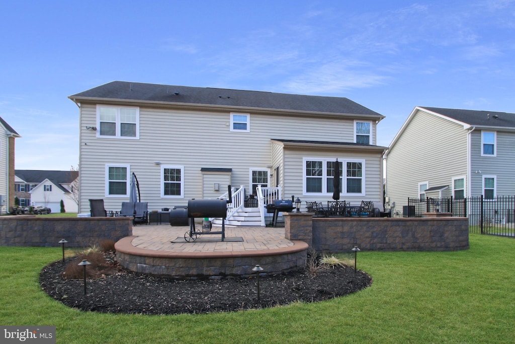 back of house featuring a patio area, a yard, and fence