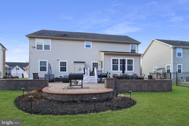 back of house featuring a patio area, a yard, and fence