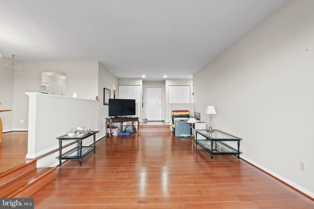 living area with light wood finished floors, recessed lighting, and baseboards