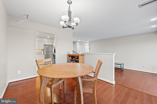 dining room featuring recessed lighting, visible vents, baseboards, and hardwood / wood-style flooring