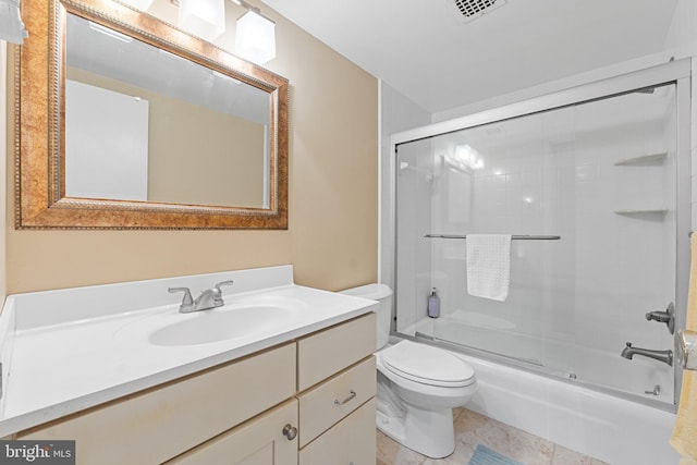 full bathroom featuring visible vents, toilet, combined bath / shower with glass door, and vanity