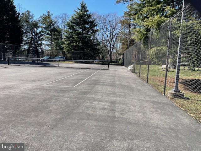 view of tennis court with fence