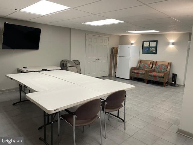 dining area with a paneled ceiling