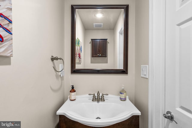 bathroom featuring visible vents and a sink