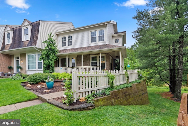 view of front of house with a front lawn, covered porch, brick siding, and roof with shingles