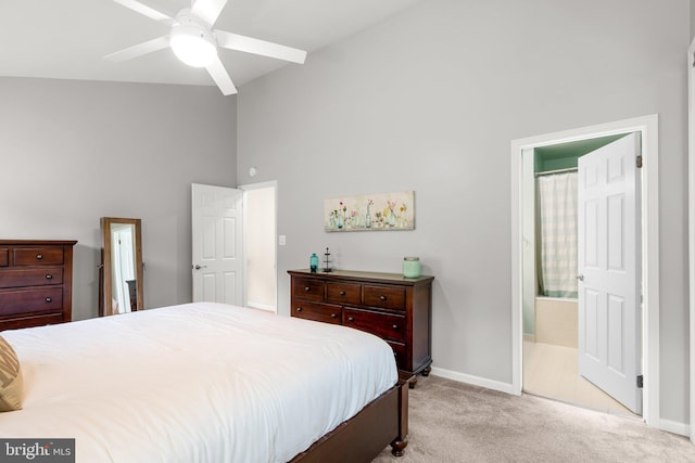 carpeted bedroom with baseboards, ensuite bathroom, and high vaulted ceiling