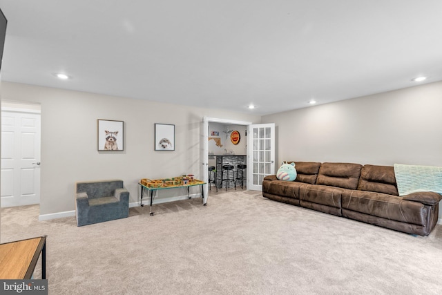 living room with recessed lighting, baseboards, and carpet floors