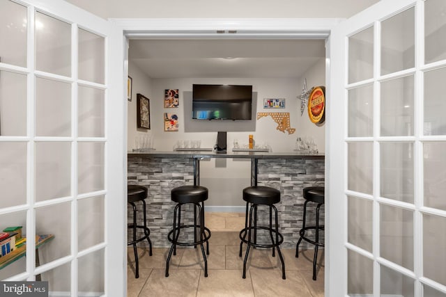 bar with tile patterned floors and bar