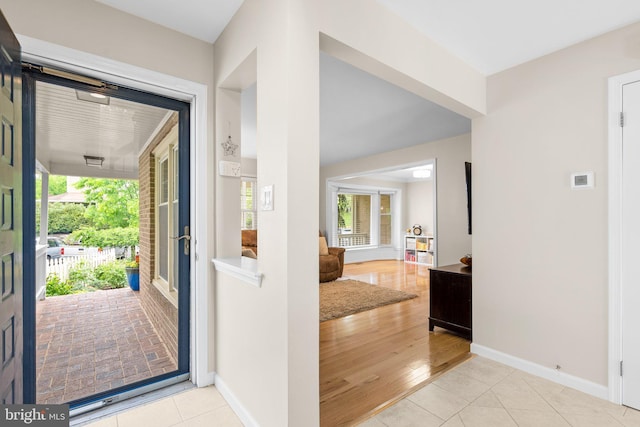 entryway with tile patterned floors and baseboards