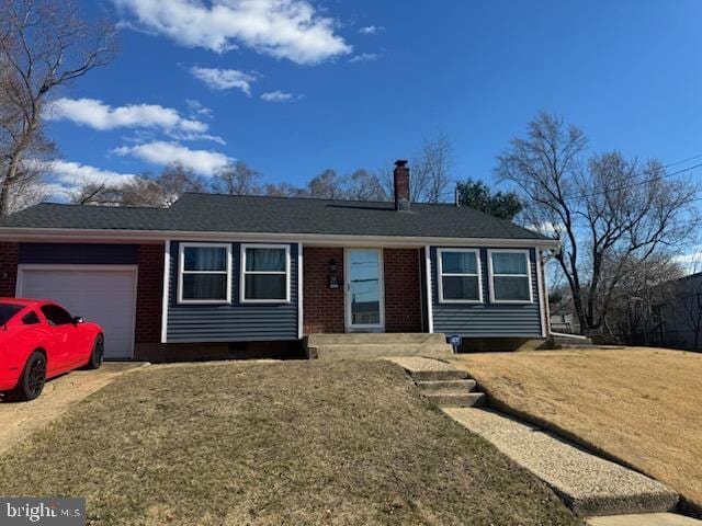 single story home featuring brick siding, a chimney, and an attached garage