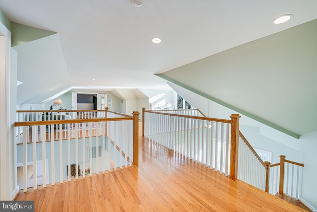 hall with recessed lighting, lofted ceiling, and wood finished floors