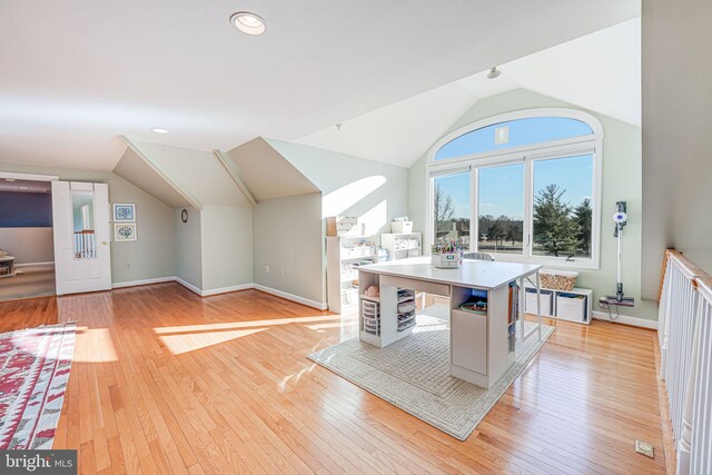 additional living space featuring baseboards, lofted ceiling, and light wood-style floors