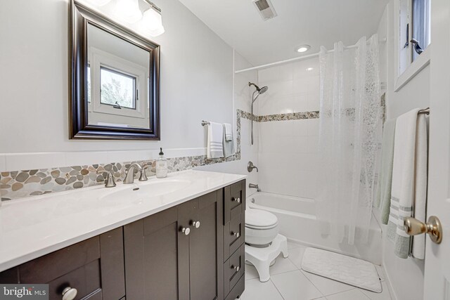 bathroom with tile patterned floors, visible vents, shower / bath combo with shower curtain, toilet, and vanity