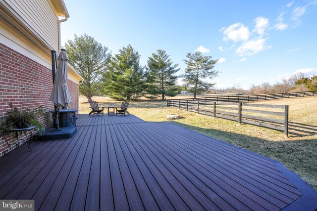 wooden deck with a lawn and fence