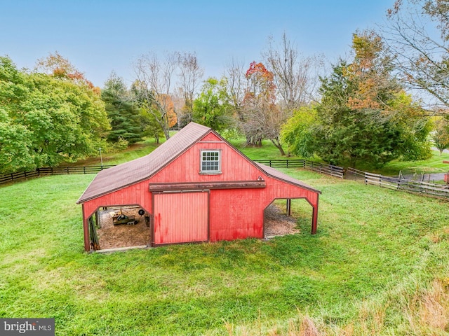 view of outbuilding featuring an outdoor structure and fence