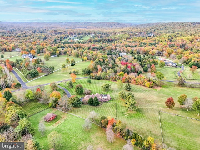 drone / aerial view featuring a forest view and a rural view