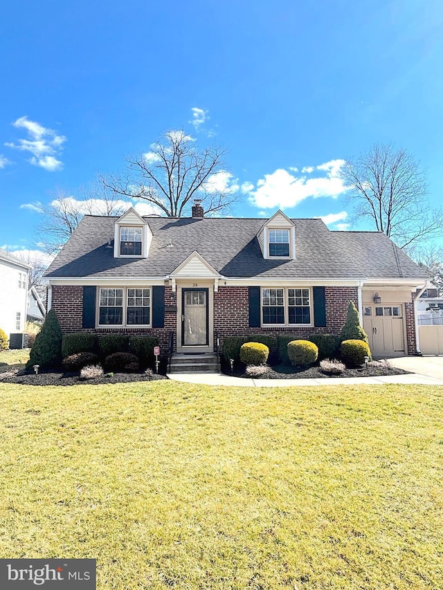 cape cod home featuring a garage, driveway, a front lawn, and brick siding