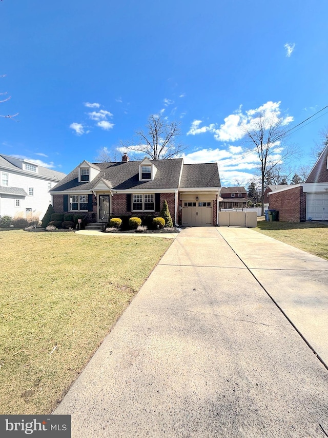 view of front facade with concrete driveway, roof with shingles, an attached garage, a front yard, and brick siding