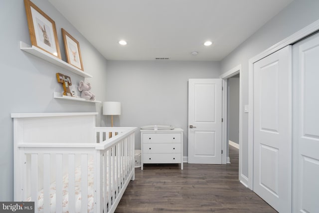 unfurnished bedroom featuring visible vents, baseboards, dark wood finished floors, recessed lighting, and a closet