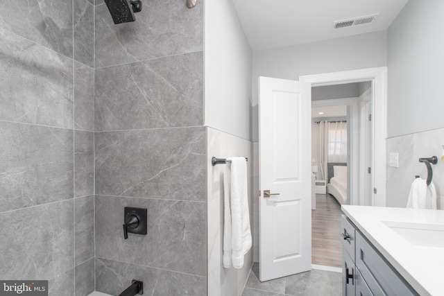 bathroom featuring vanity, a shower, visible vents, and ensuite bathroom