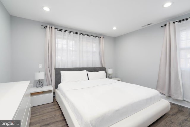 bedroom with visible vents, recessed lighting, and wood finished floors