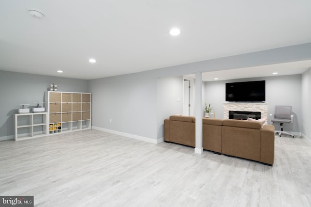 living room featuring recessed lighting, baseboards, wood finished floors, and a fireplace