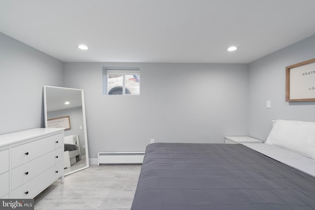 bedroom featuring recessed lighting, light wood-style floors, baseboards, and baseboard heating