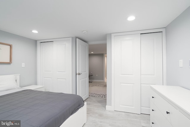 bedroom with recessed lighting and two closets