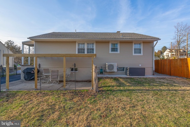 back of house with a yard, a patio, central AC unit, and fence