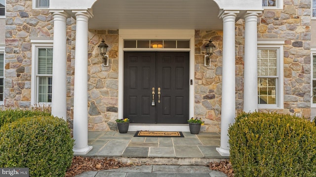 doorway to property featuring stone siding