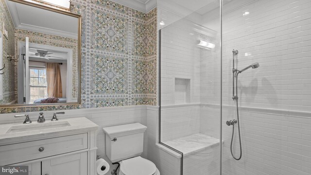 full bathroom featuring a wainscoted wall, wallpapered walls, vanity, and tiled shower