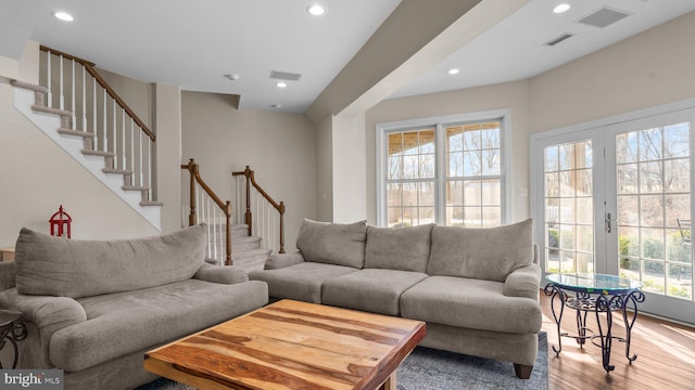 living area featuring recessed lighting, visible vents, wood finished floors, and stairs