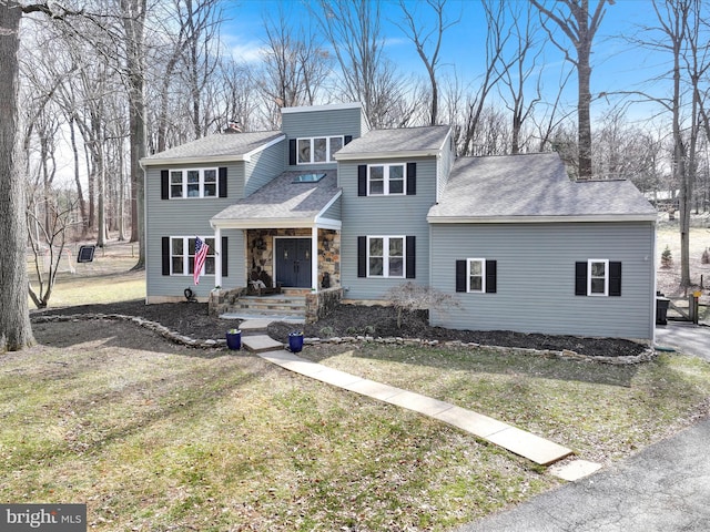 view of front of home featuring stone siding and a front lawn